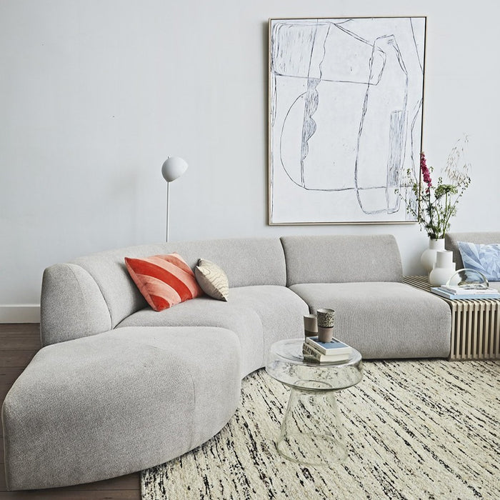 mid century modern living room with grey sofa and glass accent table