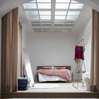 bedroom with tall standing mirror, open wardrobe and blue velvet hocker