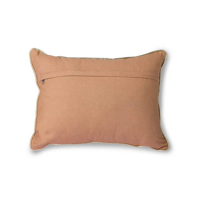 back of a blushed colored pillow with a silver trim and zipper