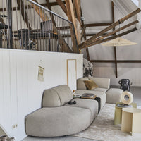 seating area with a super large triangle shaped wicker pendant light