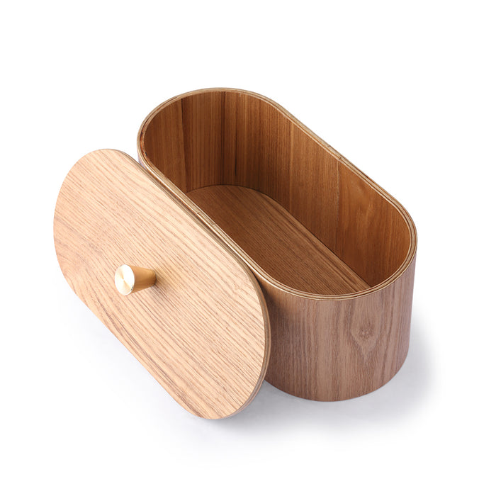 oval shaped natural colored wooden box in oval shape with lid with brass knob