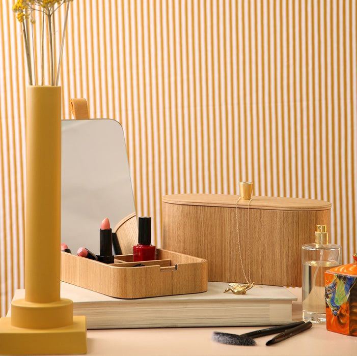 yellow striped wall paper and yellow vase with willow wooden mirror and oval box
