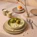 tablesetting with salmon table clot and gradient ceramics in the mix