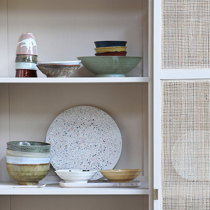 sand colored cabinet with Japanese inspired Kyoto ceramics in soft earth and pastel colors
