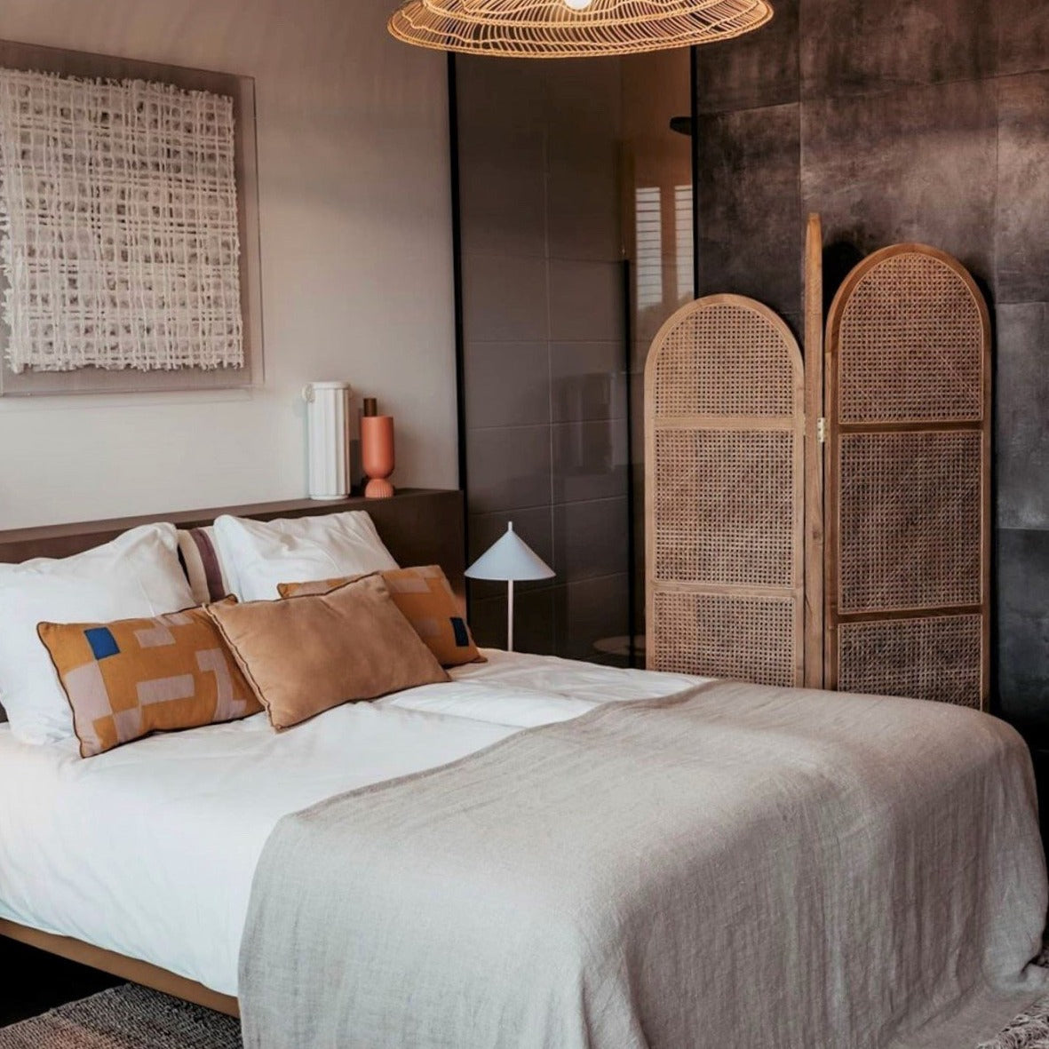bedroom with natural linen bedcover and natural wood roomdivider