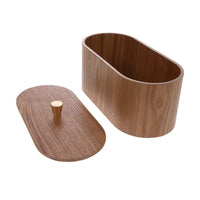 oval shaped box with removable lid made from brown willow wood with visible nerves and a brass colored knob 
