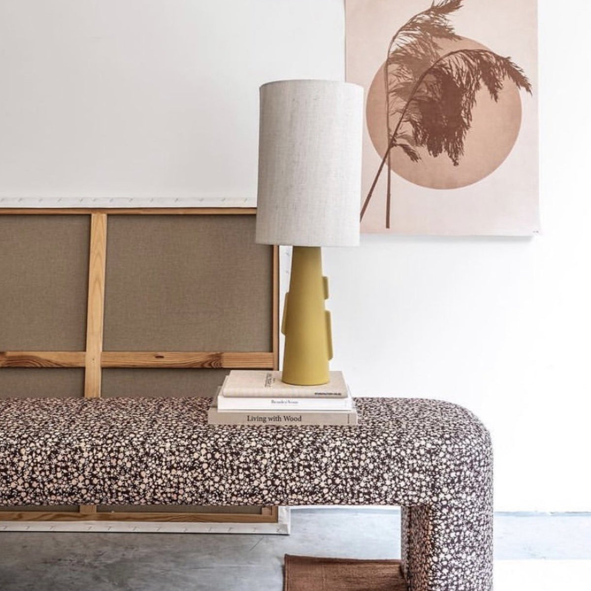 bench with vintage floral print and table lamp on a stack of books