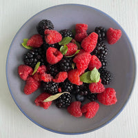 purple serving bowl with raspberries and mint 