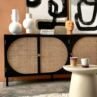 black sideboard with cane webbing detail doors