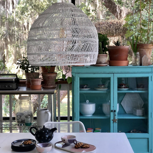 covered porch with white hanging basket light and turquoise cabinet