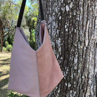 pink colored leather and suede bag with shoulder strap