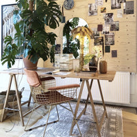 desk made of teak wood trstle table and metal wire chair with arm rest in brass 