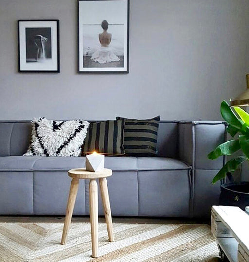 grey couch with striped throw pillows