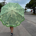 retro style sun umbrella in green flower pattern with green fringes