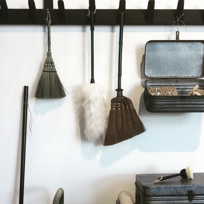 stylish dust brushes on a rack