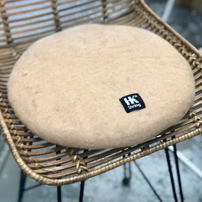 felt seat protector in camel color on rattan bar stool