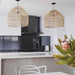 open kitchen with two medium wicker lights natural over a counter island