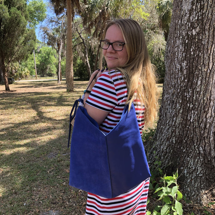 amber in striped dress and blue leather bag