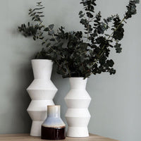 white vase together with brown blu vase 