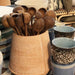 organic shaped wooden spoons in terracotta pot