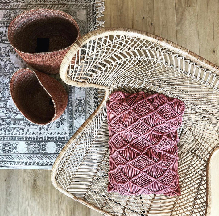 macreme textured throw pillow in terra red in natural rattan egg chair