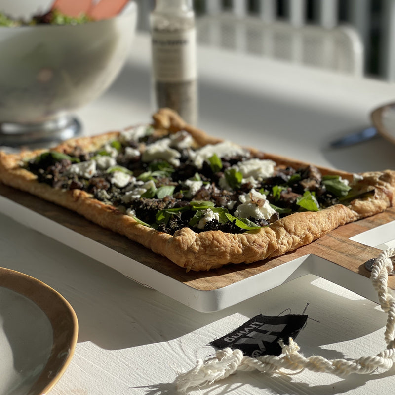 wooden serving plate with white bottom and elevated rods