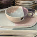 teacup from the gallery ceramics in pastel colors on an oval plate