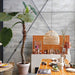 kitchen with orange tiles, a super large plant and a large handwoven natural wicker basket light 