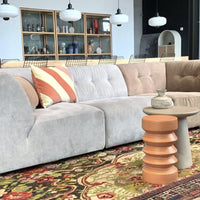 casual looking lounge room with large sofa and severel side tables