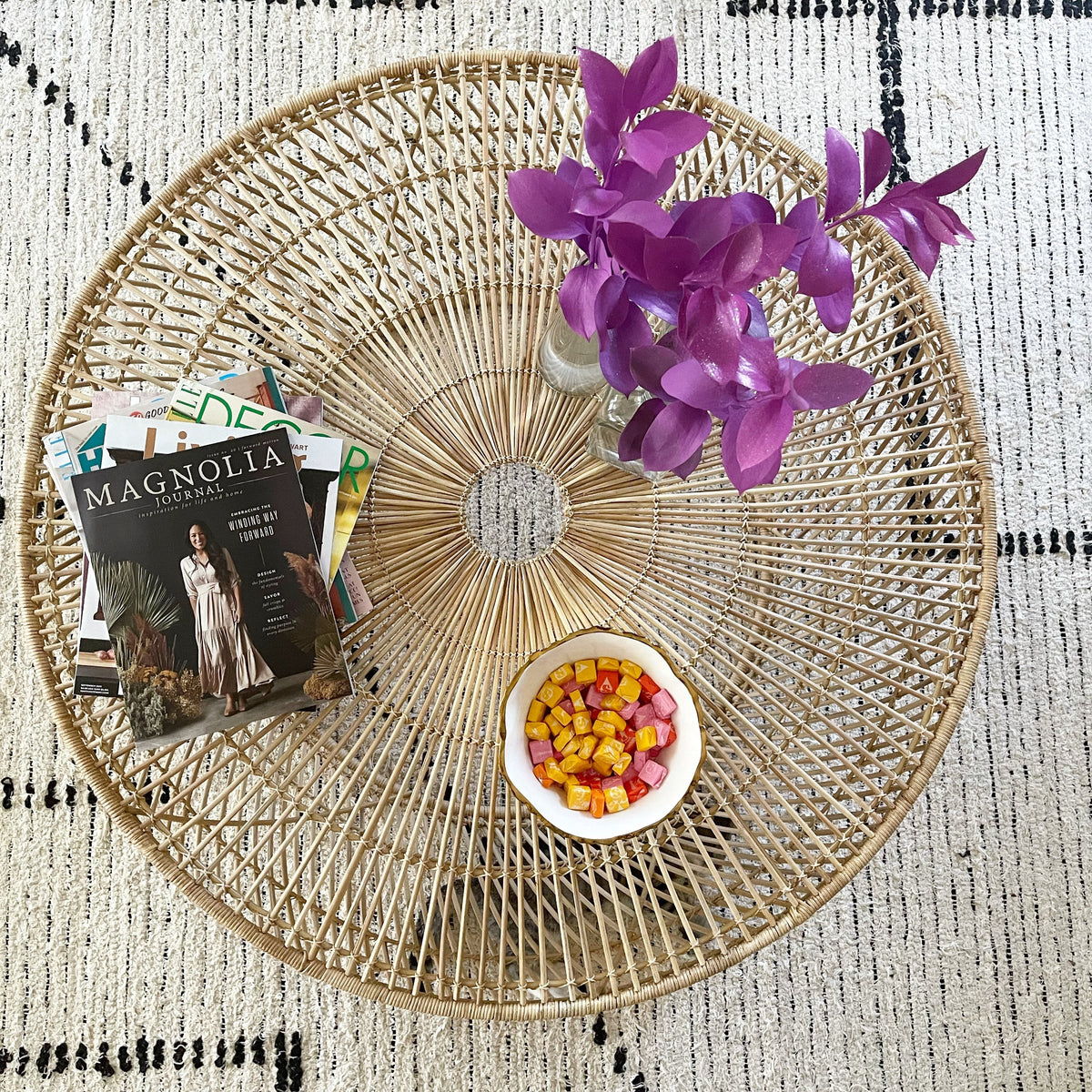 top view of round wicker coffee table with Magnolia Magazine on display