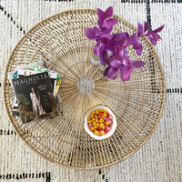 top view of round wicker coffee table with Magnolia Magazine on display