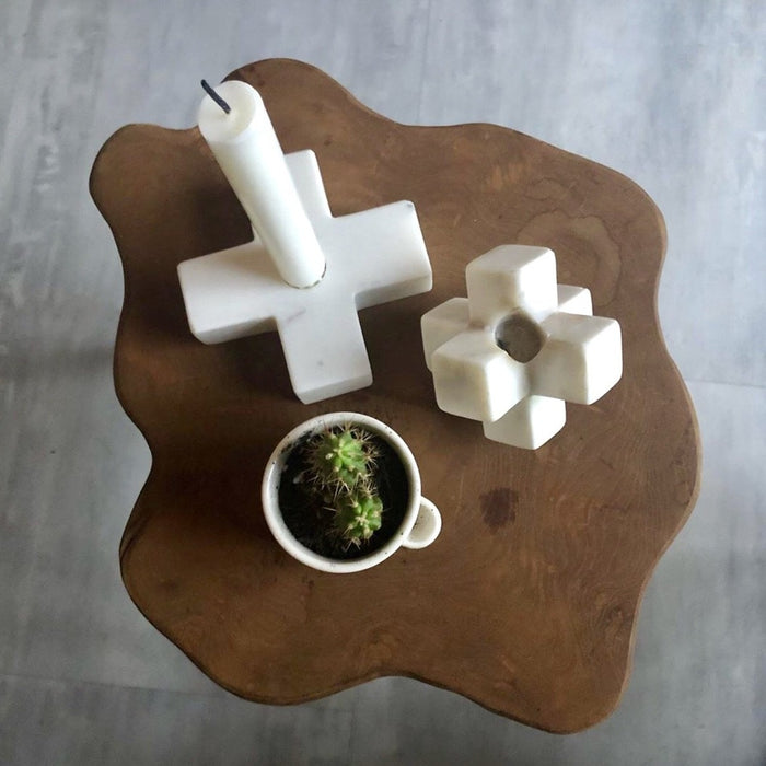wooden table with marble candle stick holders seen from the top