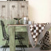 modern, rustic interior with a green table, black chair and brown and white traditional Dutch cotton tablecloth