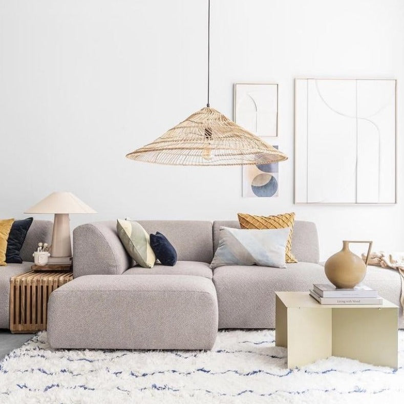 living room with sectional sofa and large natural wicker pendant light in triangle shape