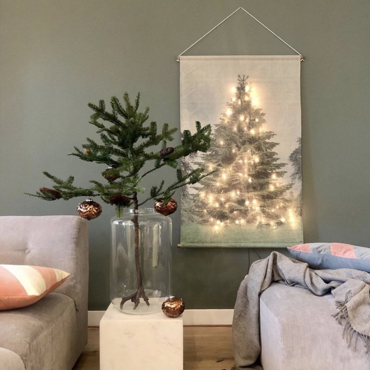 living room with green wall and Christmas three decoration on wall