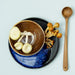 blue plate, brown bowl and teak wooden spoon