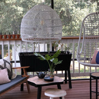 covered porch with black furniture and white wicker basket light