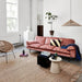 living room with pink sofa and natural color earthenware side table