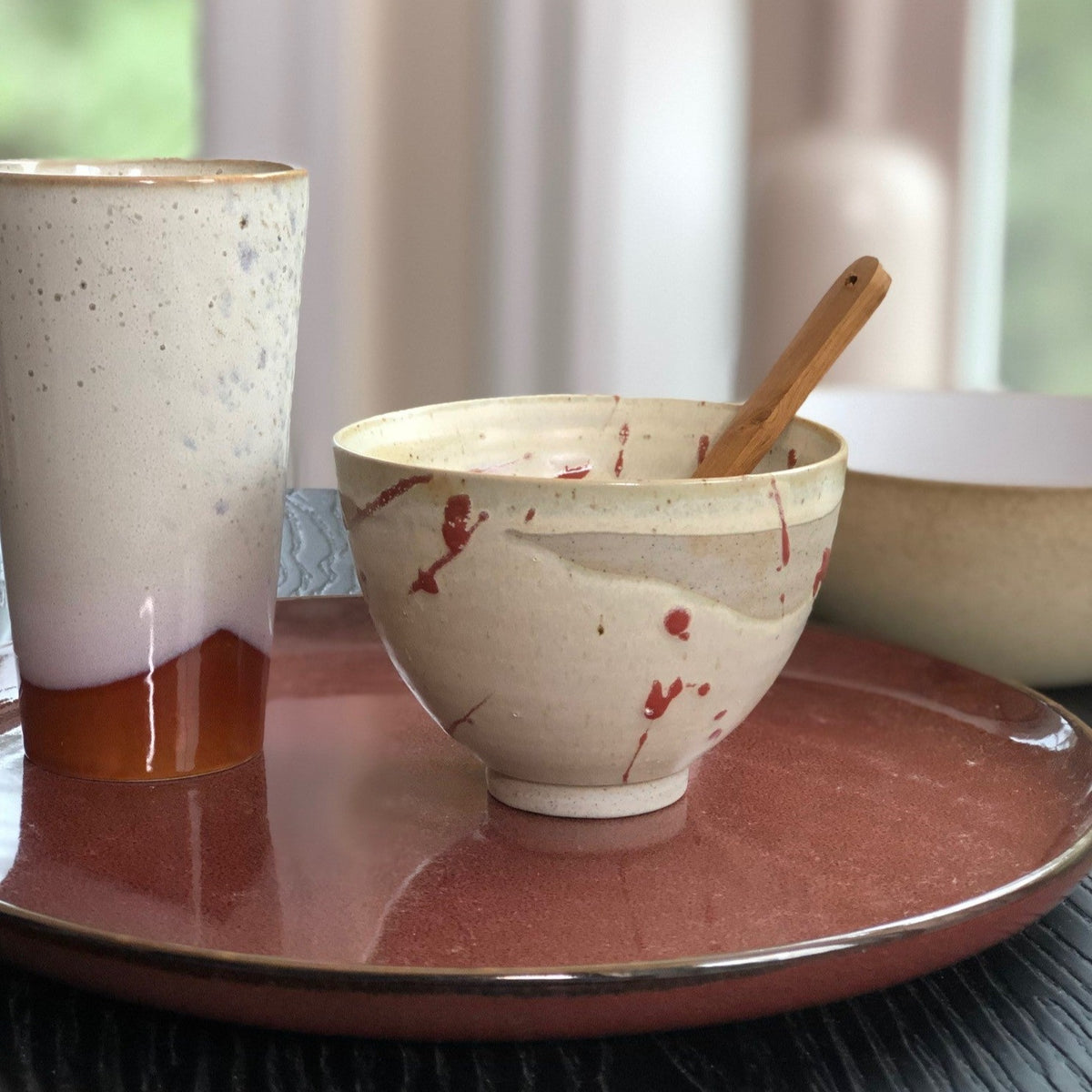 spatter bowl dinner plate and wooden spoon