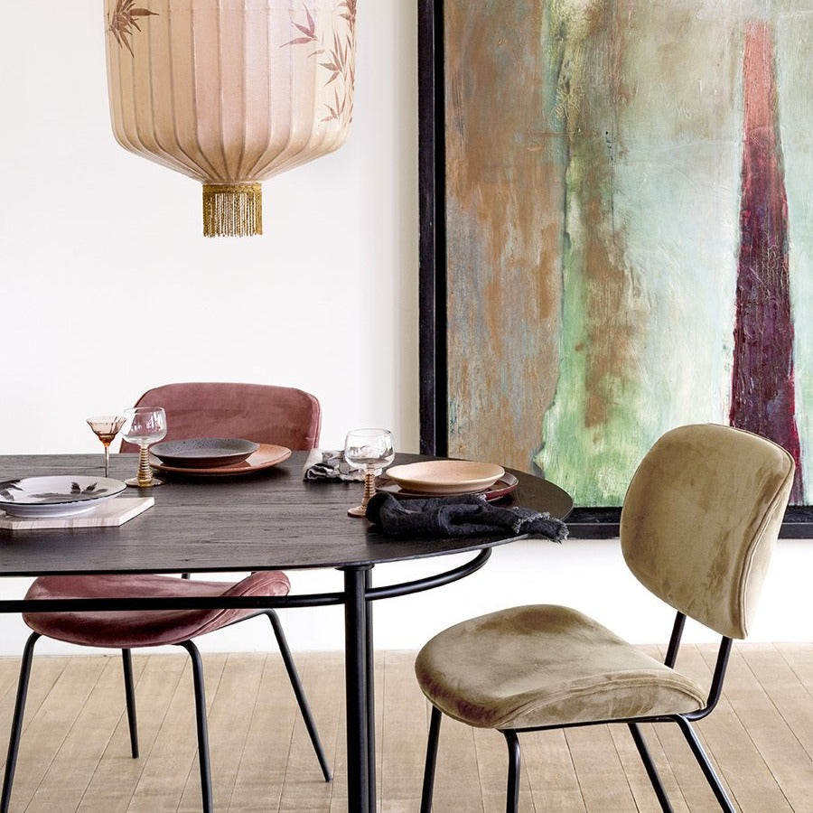 natural linen napkin with fringes in charcoal on a black oval dining table with velvet chairs