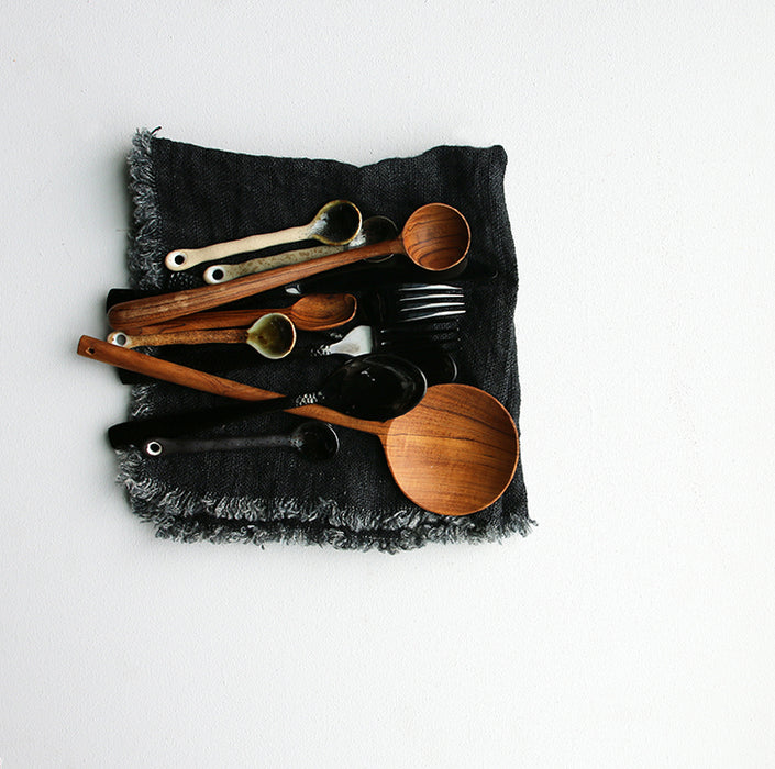 natural linen napkin with fringes in charcoal with wooden spoons
