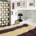 bedroom setting with striped duvet and black table lamp with hexagon shaped marblebase