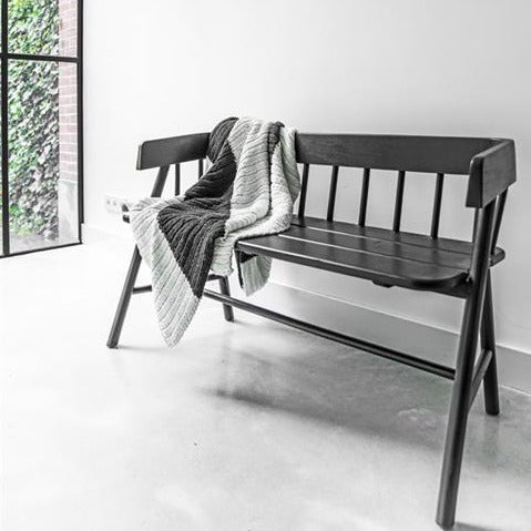 hand panited black wooden shaker bench in hall way with large fish on wall as decoration