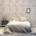 bedroom with linen bedspread and wall with retro cherry tree print wall paper by hk livingusa